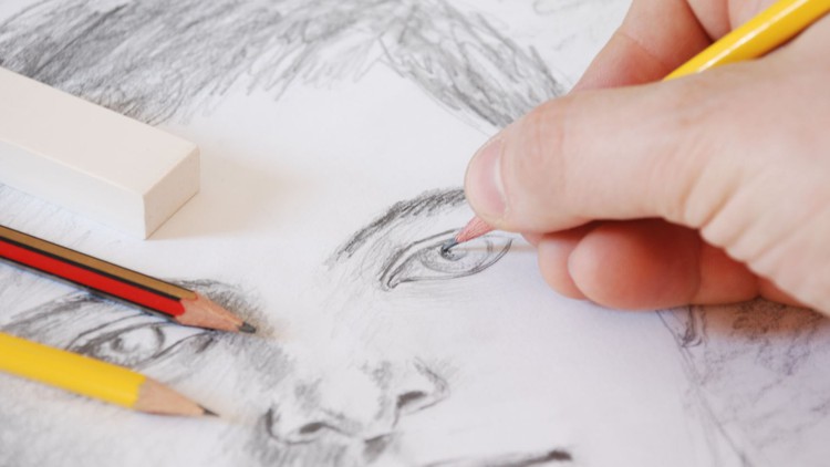 A hand drawing a face in pencil